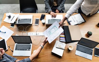 People working together at a large desk